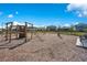 Community playground featuring wood structures, climbing features, and a swing set on a wood chip surface at 13231 Panama Beach Ct, Orlando, FL 32827