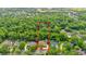 Stunning aerial view of a home surrounded by lush greenery with a large, private lot outlined in red at 1626 Wood Duck Dr, Winter Springs, FL 32708