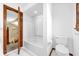 Bright bathroom featuring a tub, toilet and wood detailing at 1626 Wood Duck Dr, Winter Springs, FL 32708