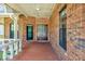 Inviting brick front porch featuring a decorative wooden door and classic architectural details at 1626 Wood Duck Dr, Winter Springs, FL 32708