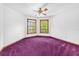 Bright bedroom featuring purple carpet and two windows at 1626 Wood Duck Dr, Winter Springs, FL 32708