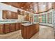 Large kitchen with an island, retro style, and seamless access to additional living spaces at 1626 Wood Duck Dr, Winter Springs, FL 32708