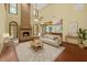 Bright living room with high ceilings, a cozy fireplace, and seamless flow into the adjacent kitchen at 1626 Wood Duck Dr, Winter Springs, FL 32708