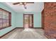 Bedroom with light teal walls, ceiling fan, and deck access via French doors with backyard views at 1626 Wood Duck Dr, Winter Springs, FL 32708