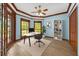 Charming home office with natural light, custom wood trim, and a serene view of the outdoors at 1626 Wood Duck Dr, Winter Springs, FL 32708