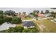 An aerial view of a home with a dark roof and lush green trees nearby at 1755 Waterview Dr, Leesburg, FL 34748