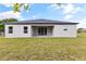 Back exterior view of the house showcasing the sliding doors and spacious backyard at 1755 Waterview Dr, Leesburg, FL 34748