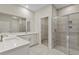 Bathroom showcases double vanity with stone countertops and walk-in shower at 1755 Waterview Dr, Leesburg, FL 34748