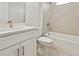 Bright bathroom featuring modern vanity with stone countertop and shower-tub combo at 1755 Waterview Dr, Leesburg, FL 34748