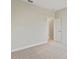 Bedroom features plush carpeting, neutral walls, and an open doorway at 1755 Waterview Dr, Leesburg, FL 34748