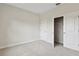 Neutral-toned bedroom showcases plush carpeting, a closet, and an entrance doorway at 1755 Waterview Dr, Leesburg, FL 34748