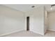 Neutral-toned bedroom showcases plush carpeting, a closet, and an entrance doorway at 1755 Waterview Dr, Leesburg, FL 34748