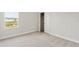 Bedroom features plush carpeting, neutral walls, large window and closet at 1755 Waterview Dr, Leesburg, FL 34748