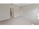Spacious bedroom featuring tray ceiling, plush carpeting, and doorway at 1755 Waterview Dr, Leesburg, FL 34748