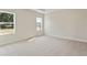Spacious bedroom features neutral walls, plush carpeting, and bright windows at 1755 Waterview Dr, Leesburg, FL 34748