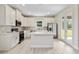 Kitchen boasts white cabinets, stainless steel appliances, center island and an adjacent dining area at 1755 Waterview Dr, Leesburg, FL 34748