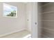 Laundry room with storage shelves, a window for natural light, and washer/dryer hookups at 1755 Waterview Dr, Leesburg, FL 34748