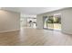 Bright living room features wood-look flooring, slider to patio and an open layout with the kitchen at 1755 Waterview Dr, Leesburg, FL 34748