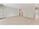 Spacious, bright living room features wood-look flooring and neutral paint at 1755 Waterview Dr, Leesburg, FL 34748