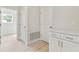 Mud room area with built-in cabinets, solid countertops and wood-look flooring at 1755 Waterview Dr, Leesburg, FL 34748