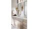 Bright bathroom features double vanity, elegant mirrors, and sleek bronze fixtures at 1910 Glencoe Rd, Winter Park, FL 32789