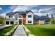 Modern two-story home featuring a manicured lawn, brick accents, and black trim windows at 1910 Glencoe Rd, Winter Park, FL 32789