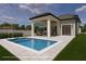 Backyard pool with covered seating area, stone accents, and modern design at 1910 Glencoe Rd, Winter Park, FL 32789
