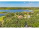 Expansive aerial view of the lakefront property with a charming home at 2910 Frontier Dr, Kissimmee, FL 34744