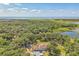 Scenic aerial view of the home surrounded by mature trees and natural landscape at 2910 Frontier Dr, Kissimmee, FL 34744