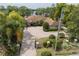 Beautiful home with manicured landscaping, a circular driveway, and picturesque lake views at 4469 Old Bear Run, Winter Park, FL 32792