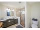 Stylish bathroom with a gray vanity, a glass shower, and modern fixtures at 4469 Old Bear Run, Winter Park, FL 32792