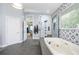 Spa bathroom featuring a soaking tub, a walk-in shower, sleek finishes, and modern accents at 4469 Old Bear Run, Winter Park, FL 32792