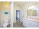 Bright bathroom featuring a white vanity, a marble countertop, and a convenient toilet at 4469 Old Bear Run, Winter Park, FL 32792