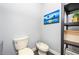 This powder room is a simple design with a commode, bidet, and wall art at 4469 Old Bear Run, Winter Park, FL 32792