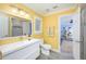 Bright bathroom with white fixtures, natural light, and a view to a bonus room at 4469 Old Bear Run, Winter Park, FL 32792