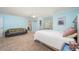 Airy bedroom with cool blue walls, a comfy couch, and a walk-in closet for ample storage at 4469 Old Bear Run, Winter Park, FL 32792