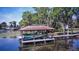 Dockside view of boat lift, with covered boat slip, and boat stored for lake access at 4469 Old Bear Run, Winter Park, FL 32792