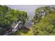 Distant aerial view of a private boat dock on the lake surrounded by trees and lush vegetation at 4469 Old Bear Run, Winter Park, FL 32792