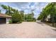 Long circular brick driveway provides ample parking, surrounded by lush landscaping for a welcoming approach to the home at 4469 Old Bear Run, Winter Park, FL 32792