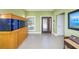Inviting entryway with tile floors, a large aquarium, and an elegant front door at 4469 Old Bear Run, Winter Park, FL 32792