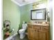 Charming half bathroom with granite countertop, decorative mirror, and stylish fixtures at 4469 Old Bear Run, Winter Park, FL 32792