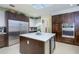 Gourmet kitchen with a stainless steel refrigerator, double oven, and a center island with a wine cooler at 4469 Old Bear Run, Winter Park, FL 32792