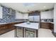 This spacious kitchen features stainless steel appliances, a center island with a wine cooler, and custom cabinetry at 4469 Old Bear Run, Winter Park, FL 32792