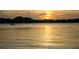 Scenic lake view with rippling water reflecting the golden sunset with boat at 4469 Old Bear Run, Winter Park, FL 32792