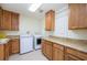 Functional laundry room with ample cabinet space and modern appliances for convenient chores at 4469 Old Bear Run, Winter Park, FL 32792