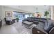 Inviting living room with modern sectional, fireplace, and views of the outdoor pool area and screened lanai at 4469 Old Bear Run, Winter Park, FL 32792