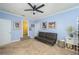 Cozy living room with blue walls, a comfortable futon, and access to the bathroom at 4469 Old Bear Run, Winter Park, FL 32792