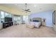 The primary bedroom features large windows with a view, a ceiling fan, and carpet flooring at 4469 Old Bear Run, Winter Park, FL 32792