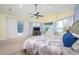 Primary bedroom with a ceiling fan, bay window, carpet flooring, and access to the patio at 4469 Old Bear Run, Winter Park, FL 32792