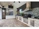 Outdoor kitchen with stainless steel appliances, stone accents and ceiling fan; perfect for entertaining friends and Gathering at 4469 Old Bear Run, Winter Park, FL 32792